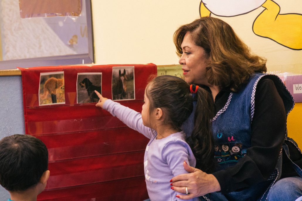 Adult and child reading together