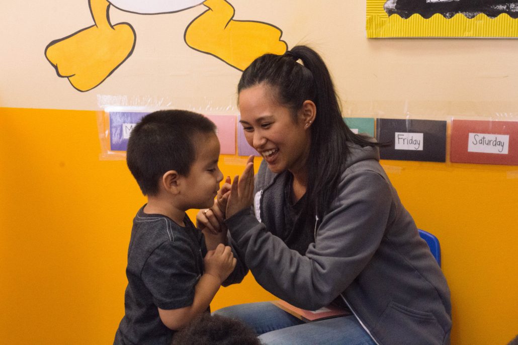 Adult and child in a group activity