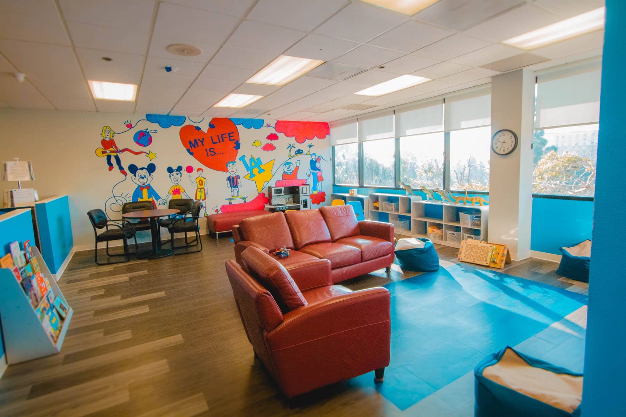 Resource room with books, mural, and seating