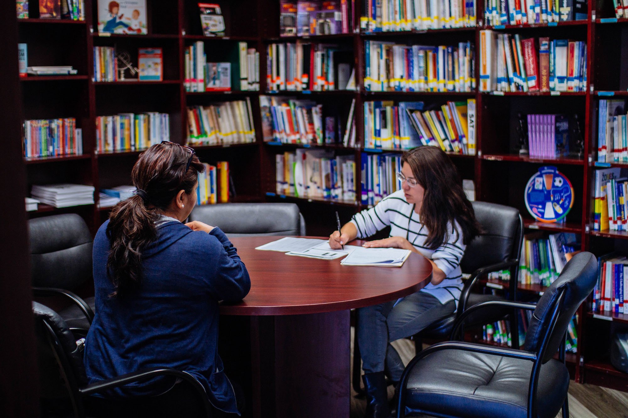 Two people at a library table
