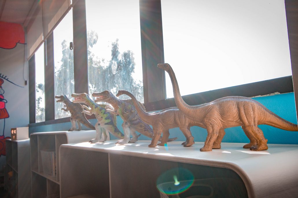 Dinosaur toys by a window