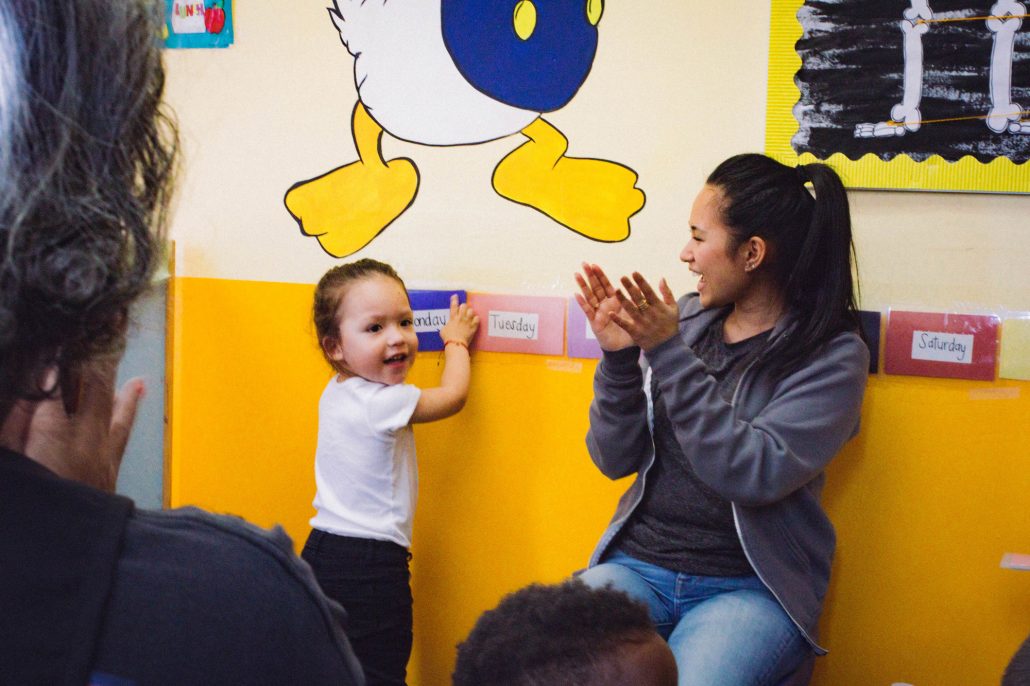 Adult leading an activity with a young child